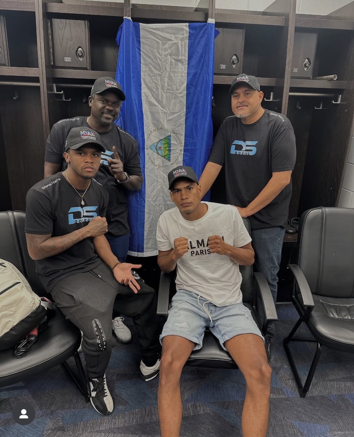 Coach Derik Santos with co-coach Smitty Francis and a fighter in the locker room